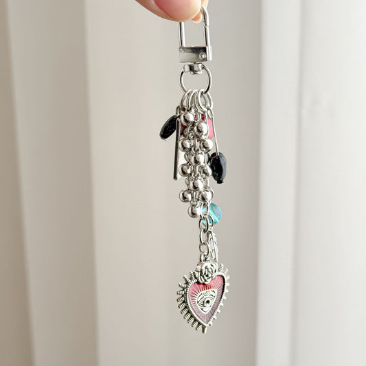 Charm keychain with red heart eye motif, fortune tarot charm, and decorative beads on durable metal ring