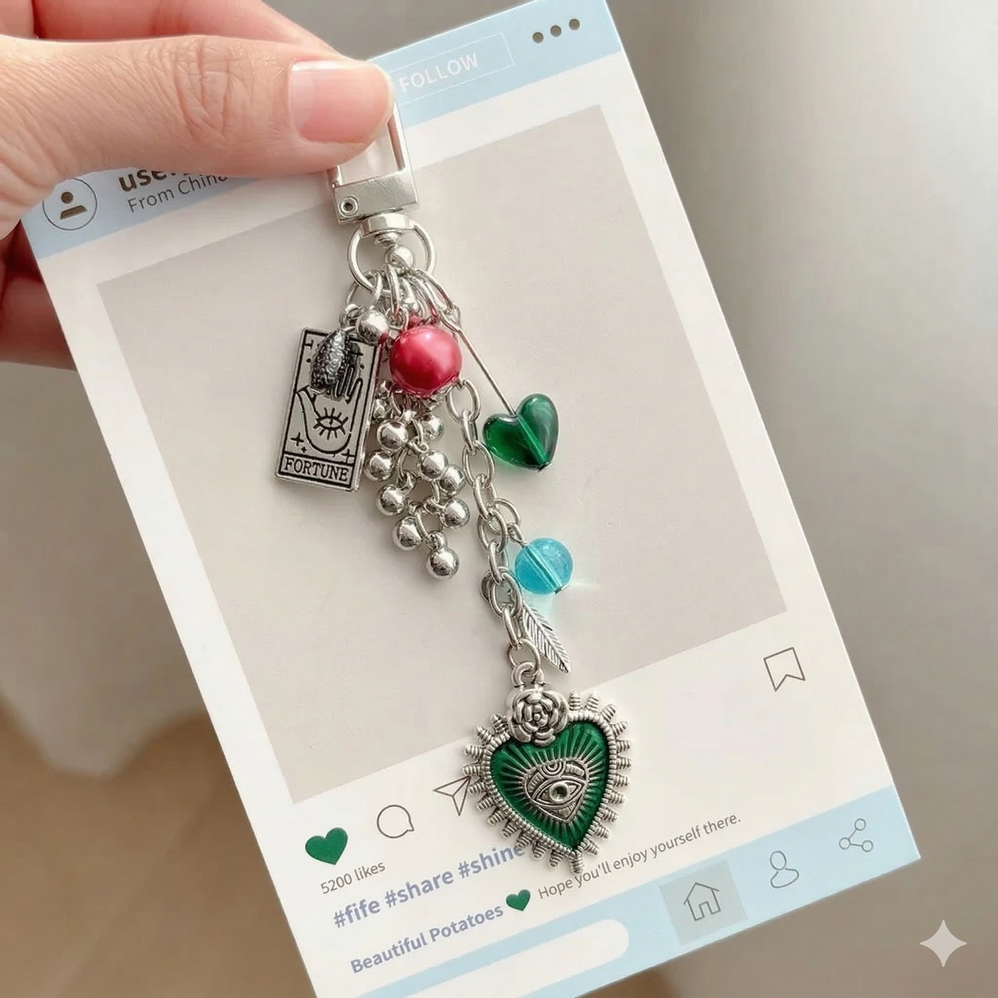 Charm keychain with red heart eye motif and fortune tarot charm on metal ring